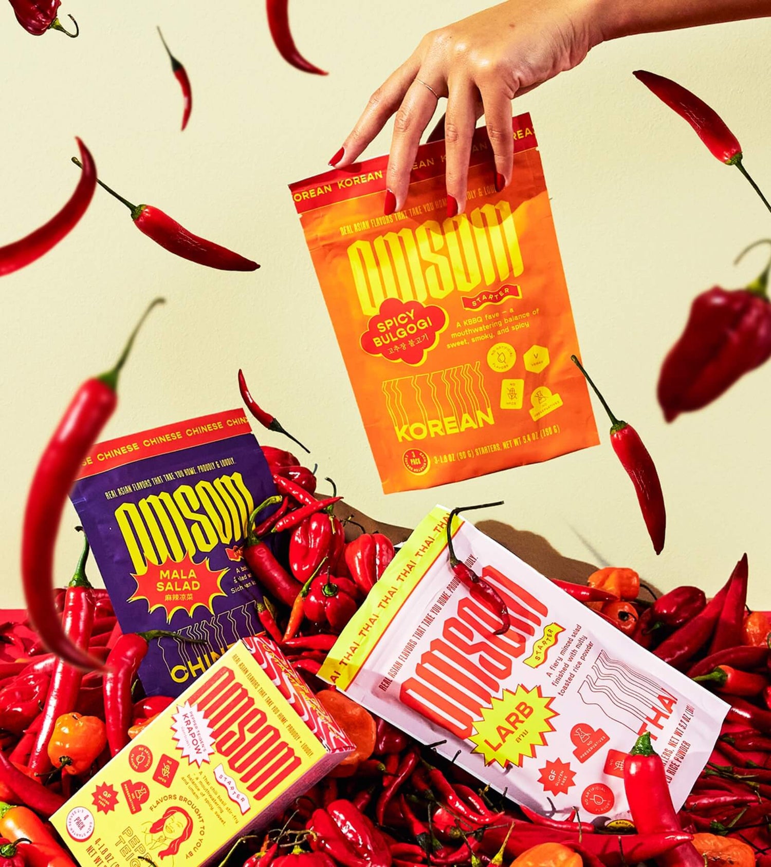 Meal starter packets sit atop a pile of hot peppers.